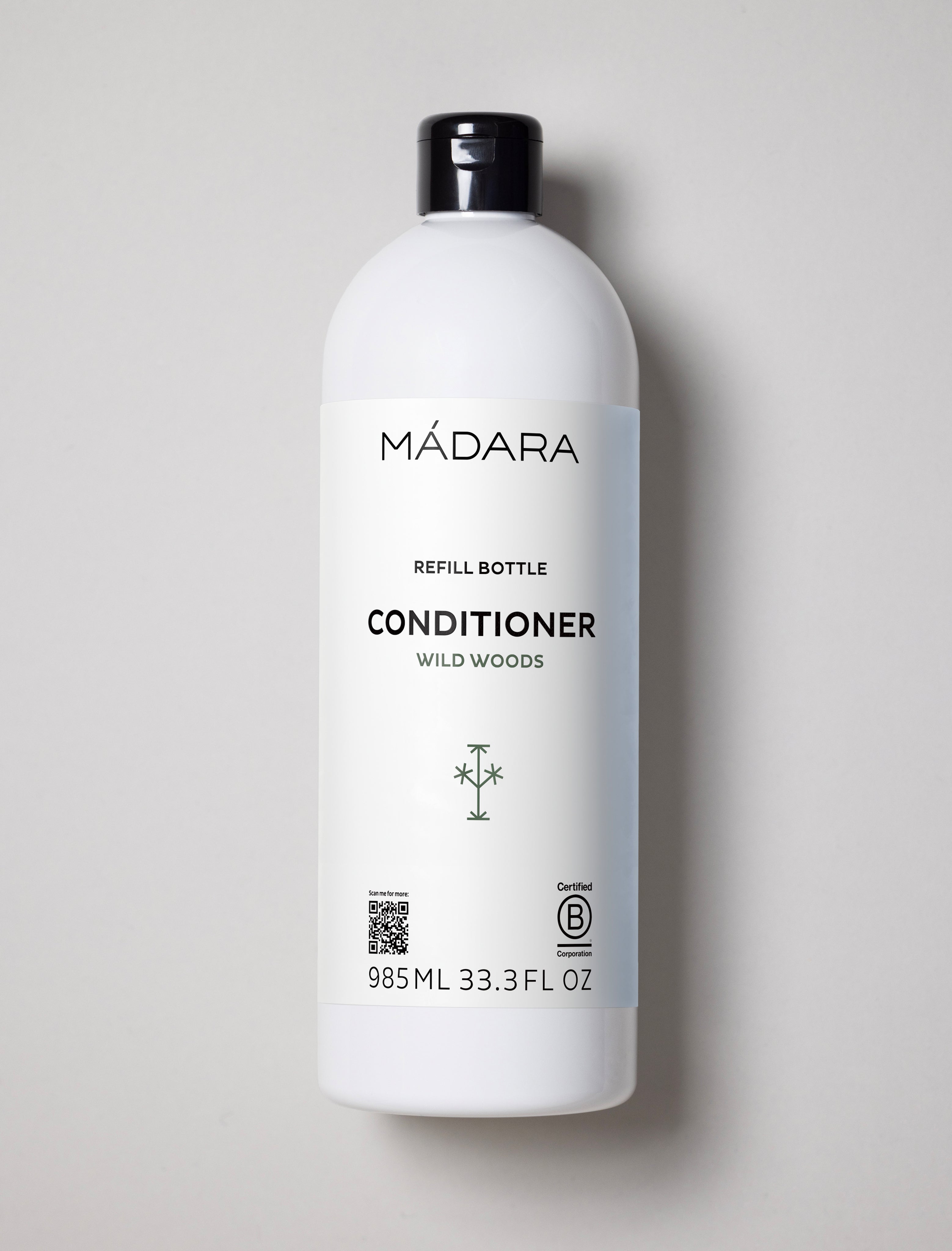 Mádara Wild Woods conditioner bottle on a light gray background